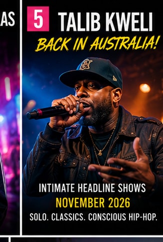 Hip-hop artist Talib Kweli performing live with microphone.