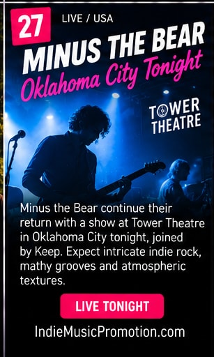 Minus the Bear guitarist bathed in dramatic teal concert spotlight at Tower Theatre.
