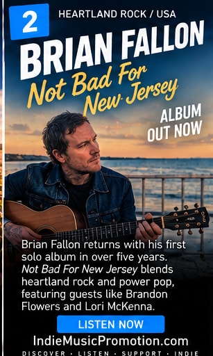 Brian Fallon holding an acoustic guitar by the coast at sunset.