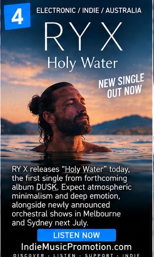 RY X in coastal ocean waters under bright serene sunlight.