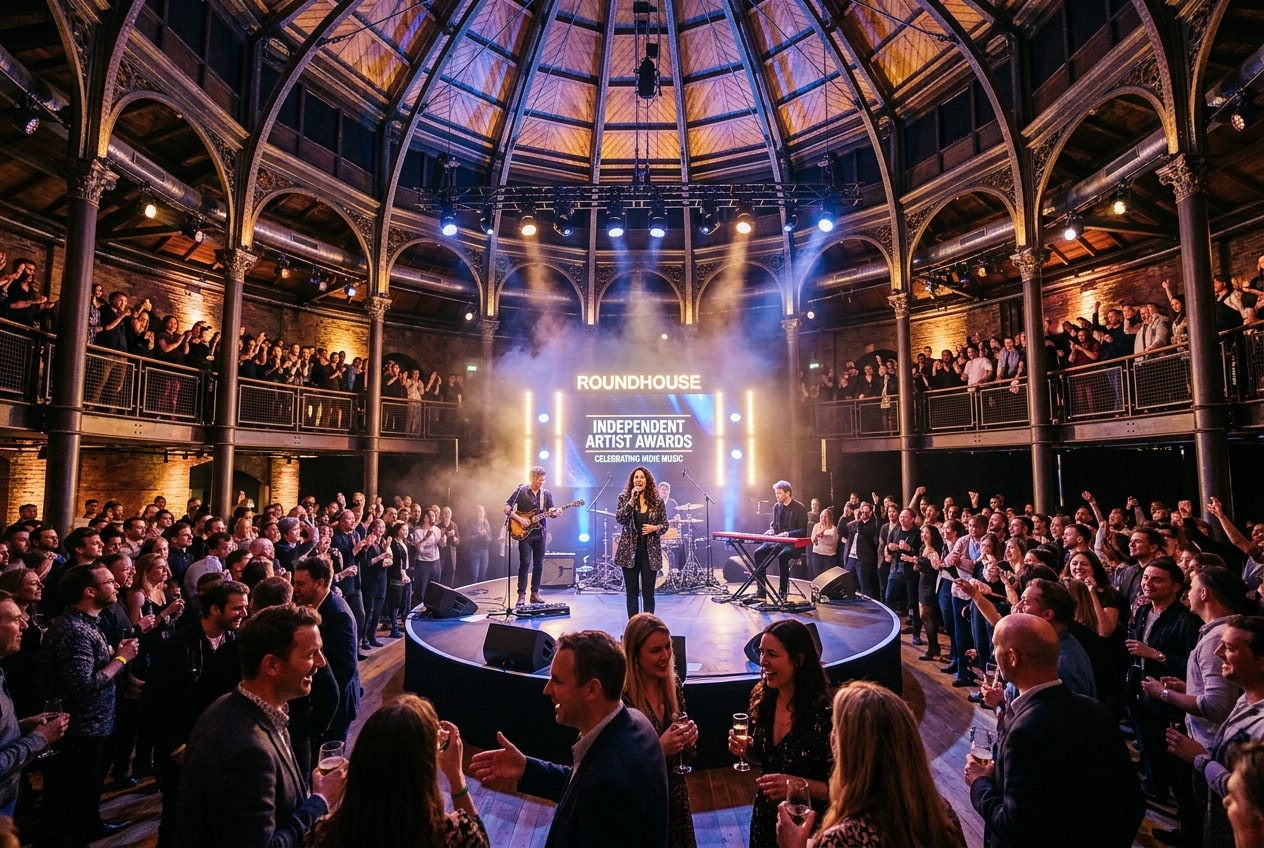 Independent Music Awards ceremony at London's Roundhouse with vibrant stage lights and cheering indie sector crowd.