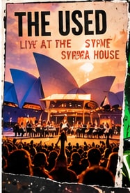 The Used performing with a live orchestra on stage in front of the illuminated Sydney Opera House sails.